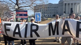 Protestors hold a sign outside of Missouri's Supreme Court on March 10, 2026. The protest was organized by People Not Politicians, a group currently working to get Missouri's redistricted map on November's ballot.