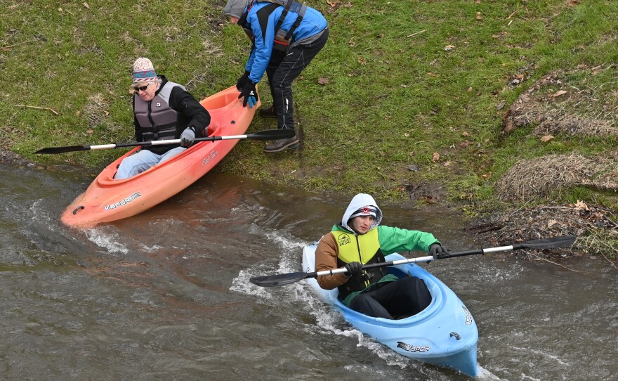 Kayakers get an assist to launch into the Lackawanna River.