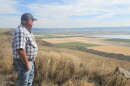 Scott Seus, president of the Klamath Water Users Association, looks over the Tule Lake National Wildlife Refuge from Sheepy Ridge on Aug. 20, 2026. Seus supports a proposal to circulate water through agricultural lands and refuge wetlands before returning it to the Klamath River.