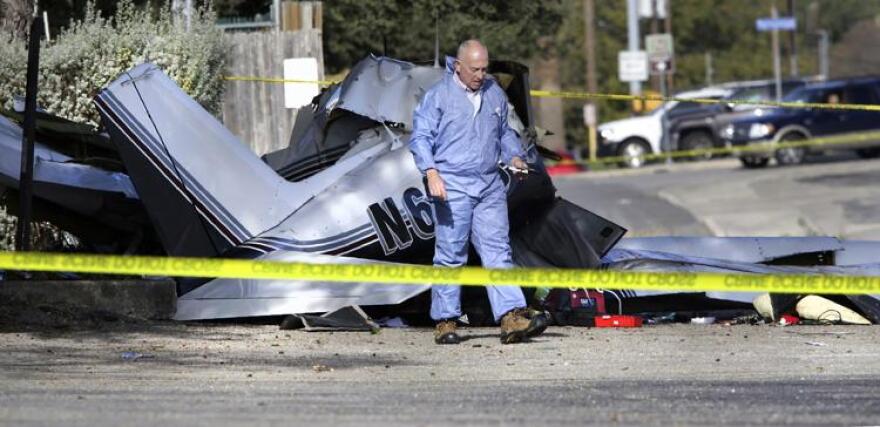 Investigators from the Federal Aviation Administration inspect and gather information at the scene of a small private plane crashed on Monday in San Antonio. 