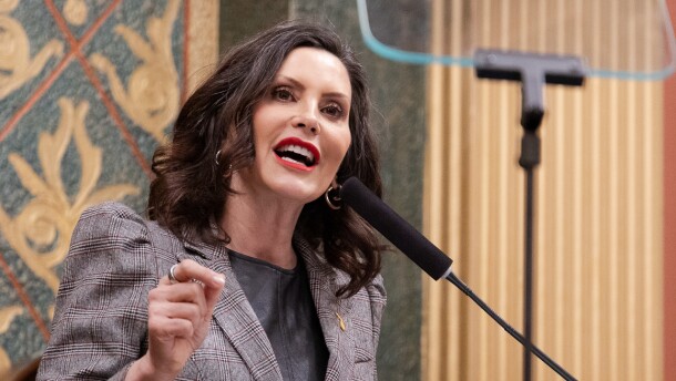Gov. Gretchen Whitmer stands at a podium in the state capitol.