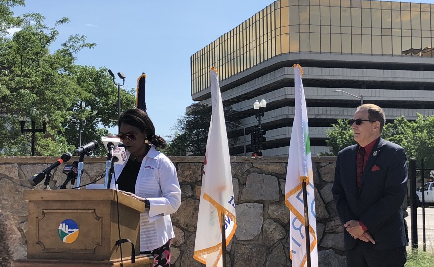 Peoria Public Schools Superintendent Dr. Sharon Kherat gives remarks as Second District Council Member Chuck Grayeb listens Thursday during a ceremony recognizing longtime educator and community advocate Aurthur Mae Perkins with an honorary street renaming in downtown Peoria.