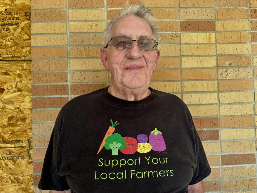 Older man with a Support Your Local Farmers t-shirt on
