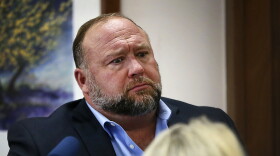 Conspiracy theorist Alex Jones attempts to answer questions about his emails asked by Mark Bankston, lawyer for Neil Heslin and Scarlett Lewis, during trial at the Travis County Courthouse in Austin, Wednesday Aug. 3, 2022. Jones testified Wednesday that he now understands it was irresponsible of him to declare the Sandy Hook Elementary School massacre a hoax and that he now believes it was “100% real."