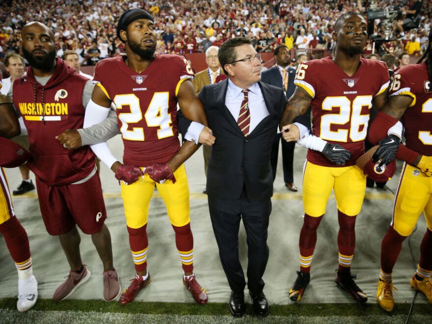 Washington Redskins Owner Daniel Synder stands with players during the national anthem before Sunday night's game against the Oakland Raiders.