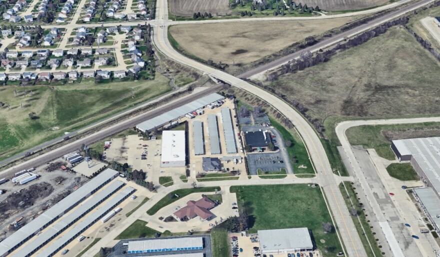 An aerial view of train tracks cutting through an industrial area
