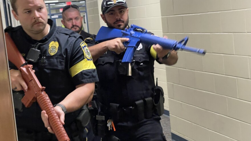 Armed police clearing school hallways during an active shooter drill in Waterford.