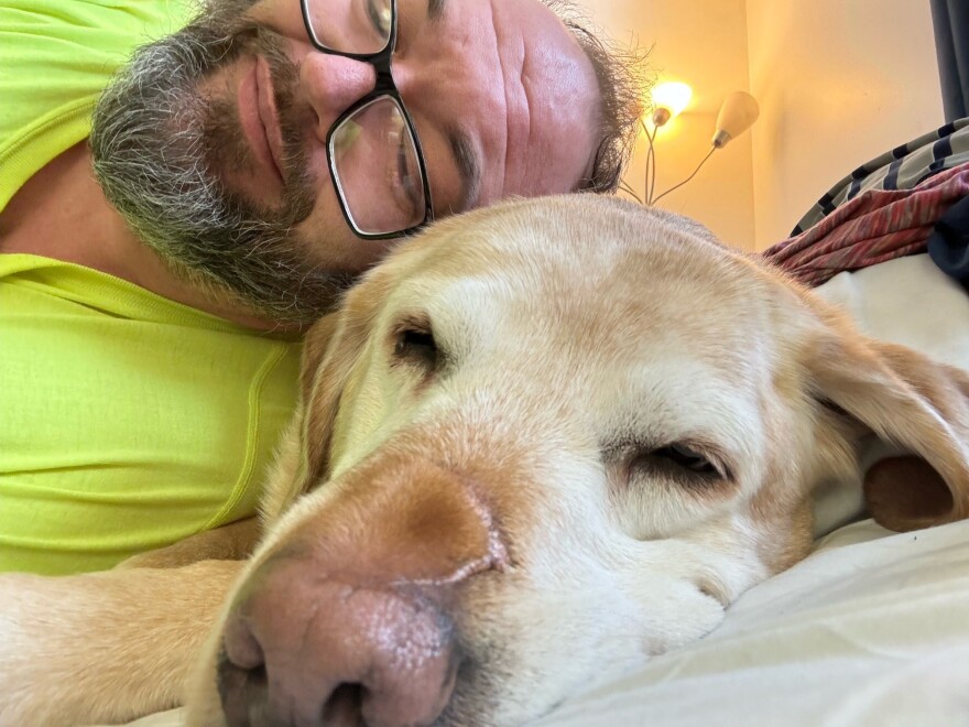 U.S. Army veteran Phil Bauer cuddles with his service dog, Champ. They both appear in "To Be of Service," a film exploring the healing bond between military veterans and their highly trained canines.