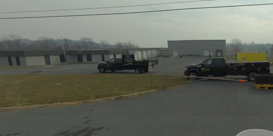 Sigora Solar trucks sit outside the Staunton-area office in November 2023, after the company was evicted. The property has since been sold.
