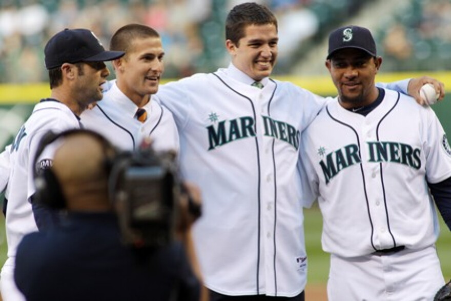 Newly signed Mariners Brad Miller, second from left, and Danny Hultzen, second from right, pose for a photo with Miguel Olivo and Adam Kennedy after they threw out the first pitches Wednesday night at Safeco Field.