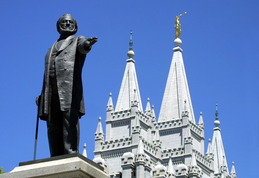  A statue of Brigham Young, second president of the Church of Jesus Christ of Latter Day Saints stands in the center of Salt Lake City with the Mormon Temple spires in the background 19 July 2001. (George Frey/AFP via Getty Images)