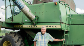 Dennis Kellogg proudly stands next to his John Deere combine from the 1970s. He said he'll use this equipment to harvest his crop later this year.