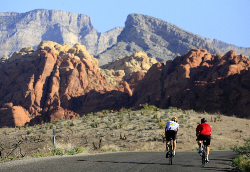 FILE - This May 6, 2006 file photo shows two cyclists riding along the 13-mile-long scenic drive at Red Rock Canyon National Conservation Area in Nevada. These towering red sandstone cliffs, some reaching 3,000 feet, is just 15 miles west of metropolitan Las Vegas.
