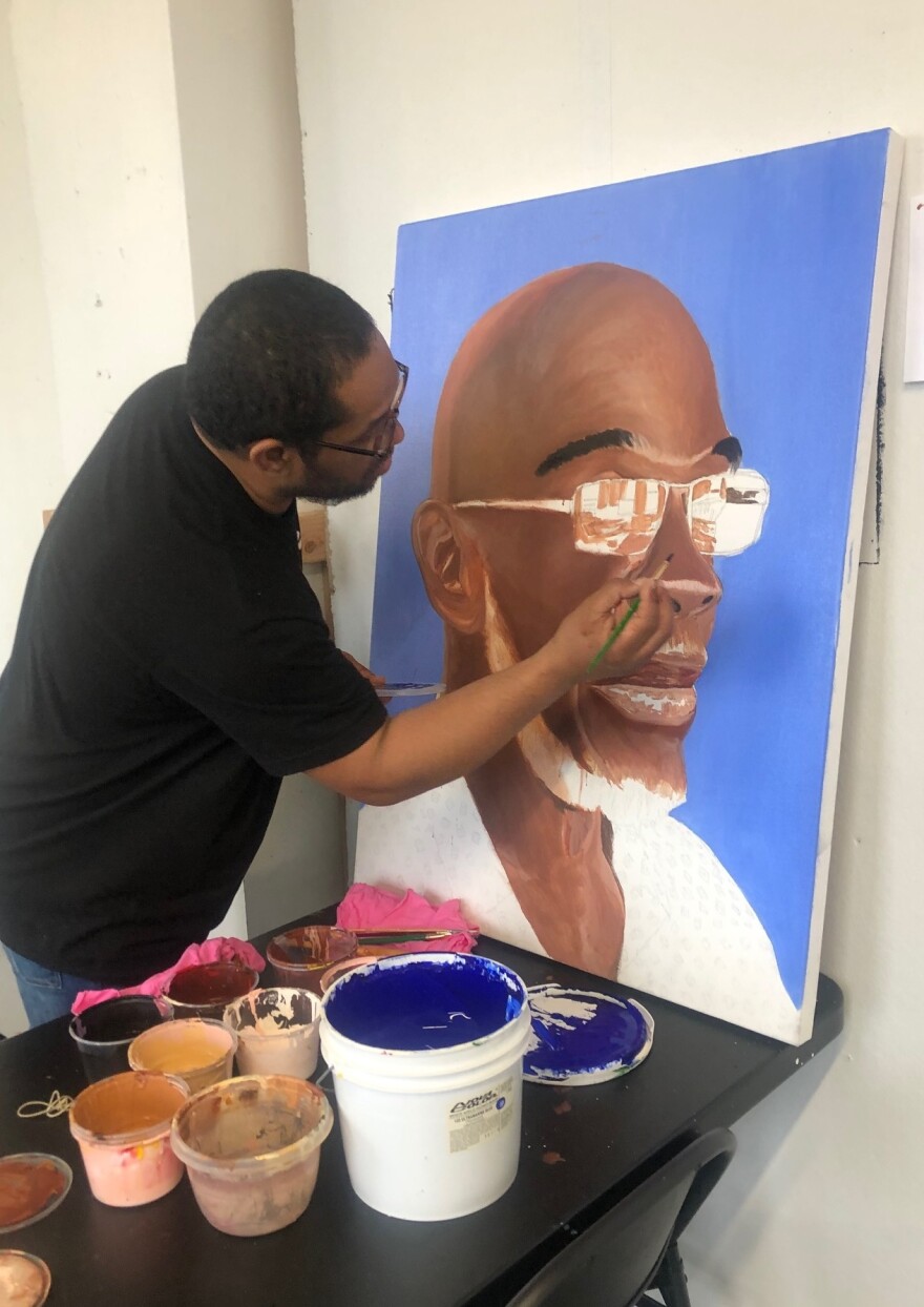 James "Yaya" Hough works on a portrait of Michael "Smokey" Wilson, who was incarcerated for life as a child and served for 46 years.