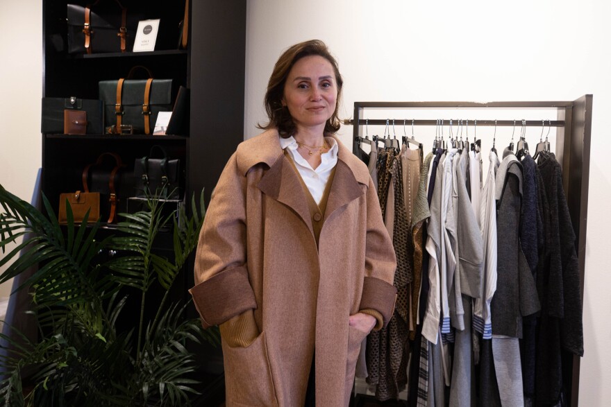 Camicie designer Maha Elazm stands next to her collection at the ATX+Egypt Fashion Pop-Up.