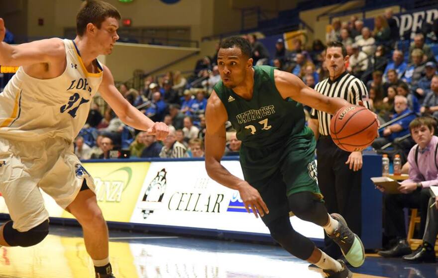 Action shot of Chris Ndow vs UNK basketball