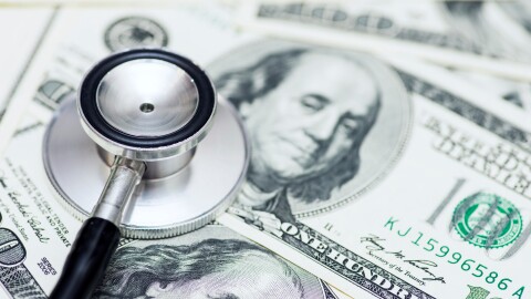 Stethoscope on the dollars. Medical costs. Healthcare payment concept. Concept of analysis of the market and economy and interest rates.