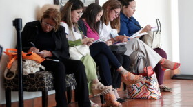 In this Tuesday, Jan. 30, 2018, file photo, women fill out job applications at a JobNewsUSA job fair in Miami Lakes, Fla. (Lynne Sladky/AP)