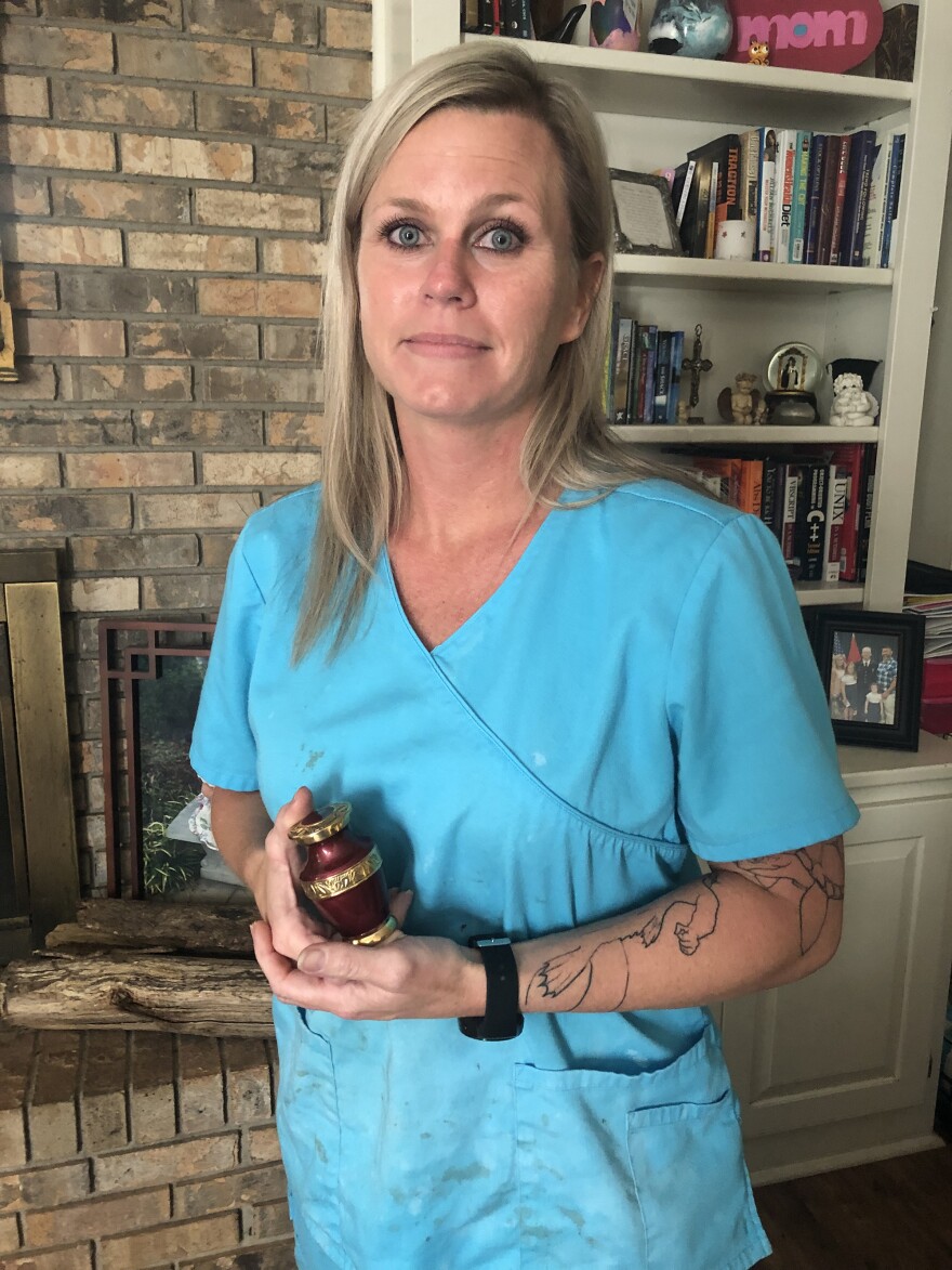 Harmony Rust-Bodke holds a urn containing the ashes of her brother Ryan Rust. He was found dead in a solitary prison cell at Alabama's Holman prison with a belt around his neck. The U.S. Department of Justice has put the state of Alabama on notice to fix dangerous and deadly prison conditions or face a lawsuit that could result in a federal takeover of the prison system.