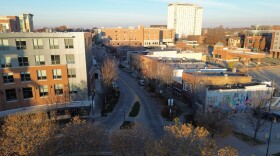 An overhead view of an urban street lined with multi story buildings