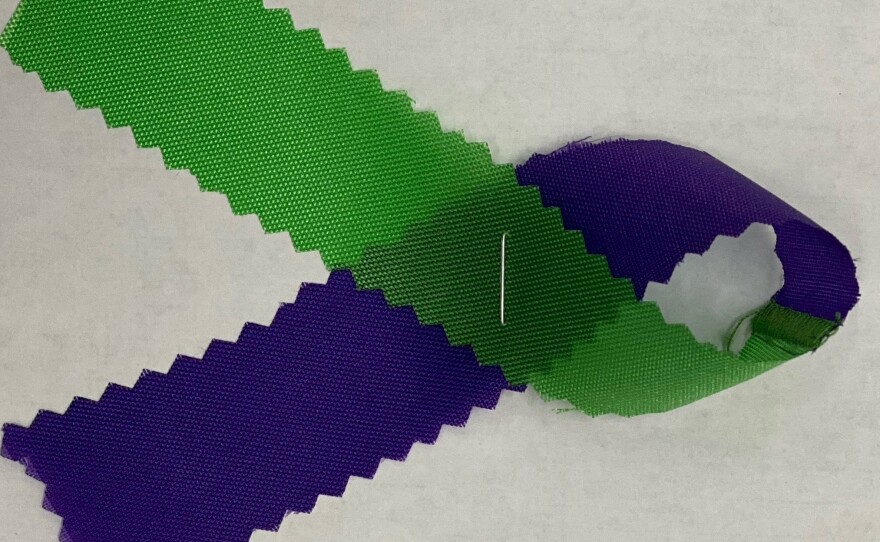 Attendants of a vigil in memory of Salman, Madiha, Yumna and Talat wore green and purple ribbons.