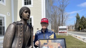 Historian Steve Connolly poses with a statue of Deborah Sampson in Sharon, Mass.
