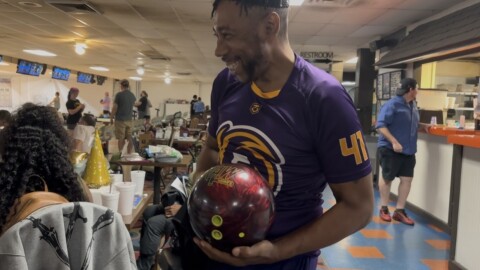 Corey Williams polishes his new bowling ball as he prepares to participate in the Strike Out Cancer event. He enjoys bowling in his free time and was glad to share the experience with friends and family.