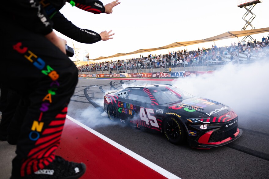 Tyler Reddick's team holds up three fingers as he parades in front of them after winning the DuraMax Grand Prix. Reddick became the first driver in NASCAR history to open the Cup Series season with three consecutive wins.