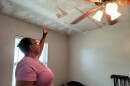 Vernita Tillman shows the patched spot on her ceiling that started out as a water spot after Hurricane Ian damaged her roof.  