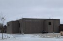 A large gray building on a snowy day. The side of the building says East Rapids Elementary in capital white letters.