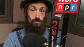 Mikey Strongmen poses with his guitar in the WBFO studio. 