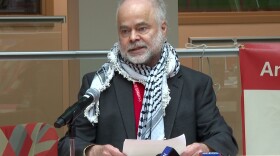 Indiana University professor Ben Robinson talks at during a "Day of Action" press conference on April 17.