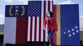 Duke women's basketball coach Kara Lawson, arrives on stage to speak to the crowd before Democratic presidential candidate former Vice President Joe Biden speaks during a campaign event at Riverside High School in Durham, N.C., Sunday, Oct. 18, 2020. 