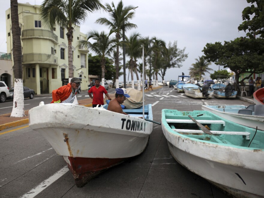 Fishermen move their boats, normally moored in the Gulf of Mexico, onto a coastal road to protect them ahead of the arrival of Tropical Storm Franklin, in the port city of Veracruz, Mexico, on Wednesday.