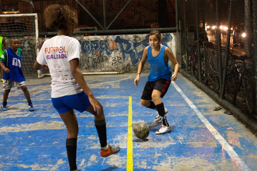 Lala (right) gets ready to pass the ball during a practice in Rocinha.