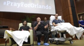 Shooting victims Patience Carter of Philadelphia (left) and Angel Santiago (right) listen as Dr. Brian Vickaryous speaks during a news conference Tuesday regarding the treatment of victims of the Pulse nightclub shooting in Orlando, Fla.
