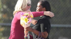 Marjory Stoneman Douglas High Assistant Principal Denise Reed hugs a school employee as she returns to campus with flowers on Feb. 23, 2018, following the mass shooting. Reed is among four school employees who are being reassigned.
