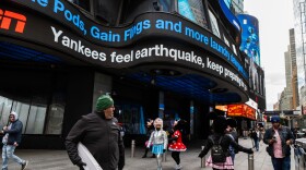 People walk around Times Square as news tickers mention the East Coast earthquake on Friday April 5, 2024 in New York. Officials say an earthquake with a preliminary magnitude of 4.8 shook the densely populated New York City metropolitan area. Residents reported they felt rumbling across the Northeast on Friday morning. The quake was centered in New Jersey about 45 miles west of New York City and 50 miles north of Philadelphia.