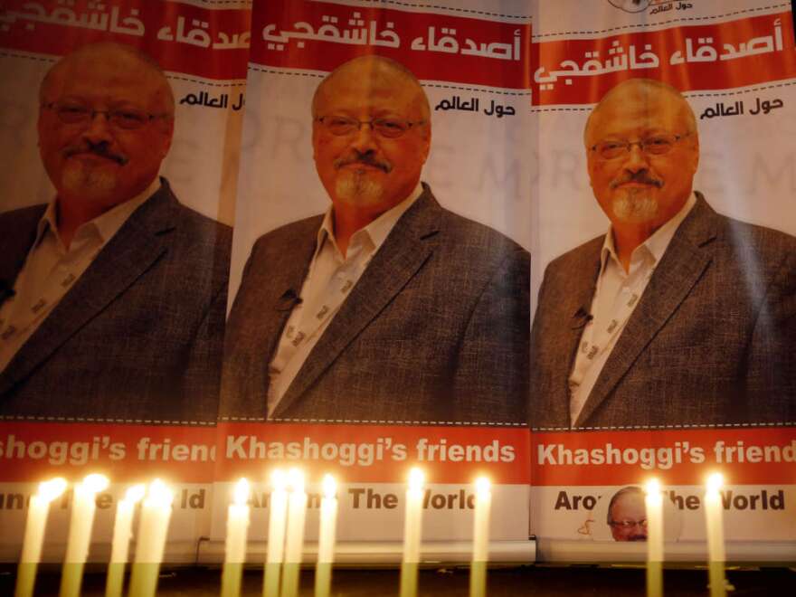 Candles burn in a memorial to slain journalist Jamal Khashoggi outside Saudi Arabia's Consulate in Istanbul in October 2018.