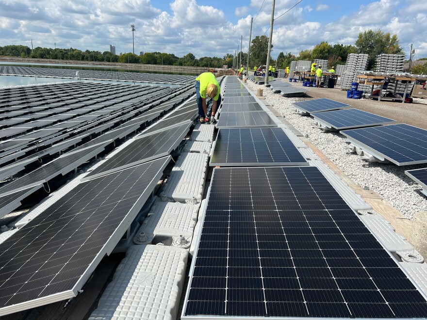 City Utilities workers work on solar panels for city's green energy initiative