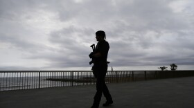 A Catalunya regional police officer patrols the Barceloneta beach front in Barcelona, Spain, Saturday, Aug. 19, 2017. Police on Friday shot and killed five people carrying bomb belts who were connected to the Barcelona van attack, as the manhunt intensified for the perpetrators of Europe's latest rampage claimed by the Islamic State group. (AP Photo/Manu Fernandez)