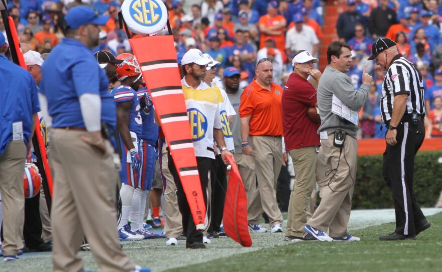 Florida Coach Will Muschamp discusses a previous play with the referee.