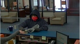 The bank robber is described as a light-skinned black male, approximately 20-35 years of age with a medium build.