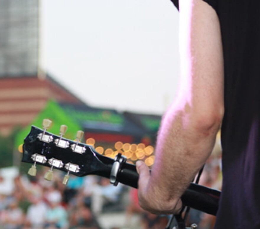 A close-up of a guitar player.