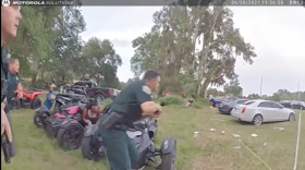 Sheriff's deputies run toward a shooting suspect in Royal Sunday evening in this image from body camera video. Image: SCSO via Facebook