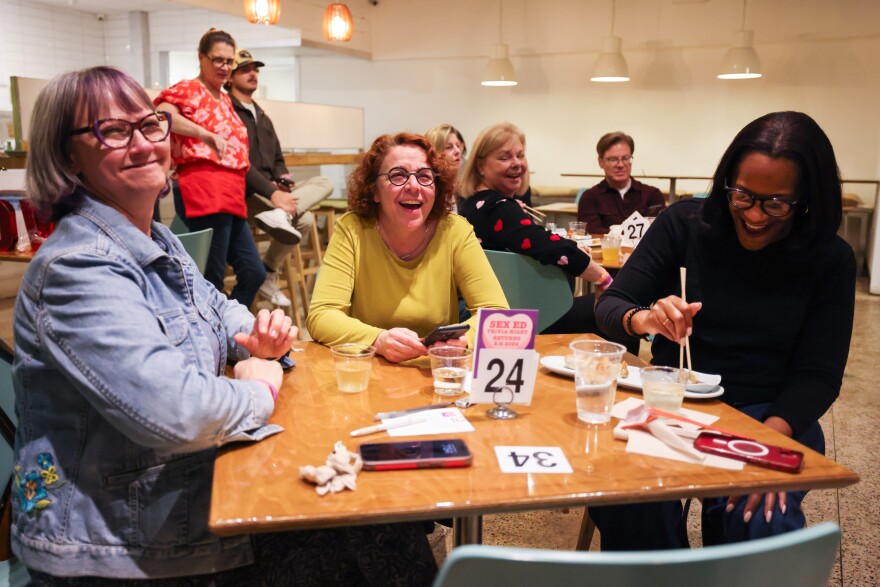 Participants laugh together during Sex Ed Trivia Night that benefits the nonprofit Wholly Informed Sex Ed on Thursday, Feb. 8, 2024, at Hello Dumpling in Dallas.