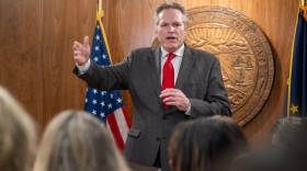 Gov. Mike Dunleavy gestures while speaking to reporters during a meeting of his 15 department commissioners on Wednesday, Jan. 21, 2026.