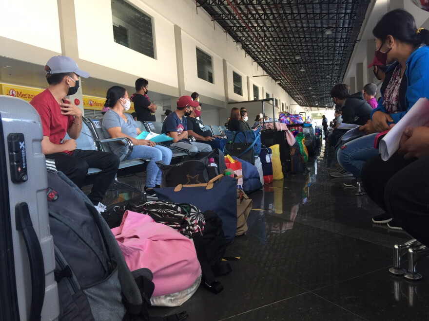 Passengers waiting to board the ferry that would transport them to Manilla. For travelers stranded in the Philippines, reaching Manilla meant the possibility of finding an international flight home. 
