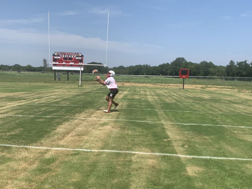 Junior Nathan Hall catches a pass during Campbell High School's first practice of the season on July 31.