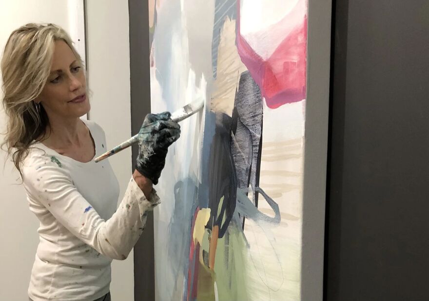 Abstract artist Cat Tesla working on composition in her studio.